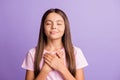 Photo of young attractive schoolgirl happy smile hands on chest dream dreamy wish pray isolated over purple color