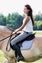 Portrait of young attractive woman riding horse in ranch Royalty Free Stock Photo