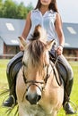 Portrait of young attractive woman riding horse in ranch Royalty Free Stock Photo