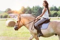 Portrait of young attractive woman riding horse in ranch Royalty Free Stock Photo