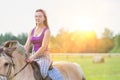 Portrait of young attractive woman riding horse in ranch Royalty Free Stock Photo