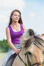Portrait of young attractive woman riding horse in ranch Royalty Free Stock Photo