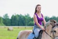 Portrait of young attractive woman riding horse in ranch Royalty Free Stock Photo