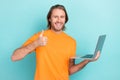 Photo of young bearded handsome programmer funny man showing thumb up like new software for his computer isolated on
