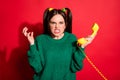 Photo of young beautiful angry furious girl hold yellow telephone after argument isolated on red color background Royalty Free Stock Photo