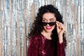 Photo of young beautiful happy cheerful flirty coquettish woman in sunglasses look copyspace isolated on shiny