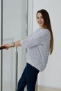 Photo of young beautiful happy smiling woman with long hair near the window. Royalty Free Stock Photo