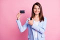 Photo of young beautiful smiling cheerful businesswoman point finger at credit card isolated on pink color background Royalty Free Stock Photo