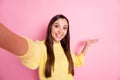 Photo of young beautiful smiling cheerful positive girl demonstrate take selfie on pink color background