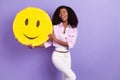 Photo of young beautiful stunning positive lovely african girl show yellow emoticon isolated on purple color background