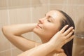 Photo of young beautiful woman taking relaxing shower
