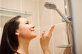 Photo of young beautiful woman taking relaxing shower.