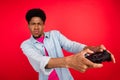 Photo of young black guy addicted play game competition console joystick weekend isolated over red color background