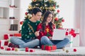 Photo of young boyfriend and girlfriend wear ugly ornament sweaters hold laptop love eshopping winter sale hold credit