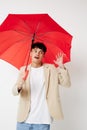 Photo young boyfriend holding an umbrella in the hands of posing fashion light background unaltered Royalty Free Stock Photo