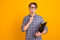 Photo of young business man hold clipboard organizer think isolated over bright color background Royalty Free Stock Photo