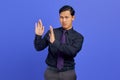 Photo of young businessman doing stop motion with palm isolated over purple background