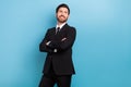 Photo of young businessman elegance wearing formal suit necktie confident folded arms look empty space isolated on blue Royalty Free Stock Photo