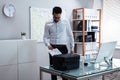 Businessman Using Printer In Office Royalty Free Stock Photo