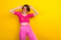 Photo of young carefree attractive lady wear pink stylish knitted crop top summertime sunglass dance have fun isolated