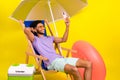 Photo of young carefree resort party comfortable lying sunbed guy blogging under umbrella selfie cadre isolated on