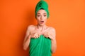 Photo of young charming lady surprised expression open mouth wear green towel turban isolated orange color background Royalty Free Stock Photo