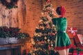 Photo of young charming woman elf decoration preparation christmas tree xmas spirit indoors inside house home Royalty Free Stock Photo