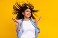 Photo of young cheerful afro american woman look empty space hair fly wind on yellow color background