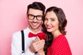 Photo of young cheerful couple lovers husband wife romantic date valentine day isolated over pink color background Royalty Free Stock Photo