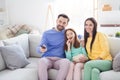 Photo of young cheerful family happy positive smile sit sofa home watch television eat popcorn switch channel remote Royalty Free Stock Photo
