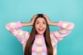 Photo of young cheerful girl amazed look empty space unexpected isolated over turquoise color background Royalty Free Stock Photo