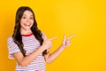 Photo of young cheerful girl happy smile indicate fingers empty space ad promo recommend advise over yellow