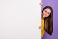 Photo of young cheerful girl hold hands paper advert announcement isolated over purple color background