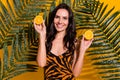 Photo of young cheerful girl hold orange slices dermatology detox vitality isolated over yellow color background