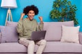 Photo of young cheerful guy celebrate lucky fists hands fan goal use laptop apartment isolated over blue color Royalty Free Stock Photo