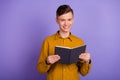 Photo of young cheerful guy good mood read book academic lesson isolated over violet color background Royalty Free Stock Photo