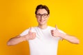 Photo of young cheerful guy show thumbs-up quality ideal advertise isolated over yellow color background Royalty Free Stock Photo