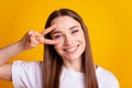 Photo of young cheerful lady good mood show fingers peace cool v-symbol isolated over yellow color background Royalty Free Stock Photo