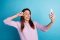 Photo of young cheerful lady take shooting selfie mobile show peace cool v-symbol isolated over blue color background