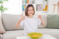 Photo of young cheerful little girl happy positive smile drink milk eat cornflakes breakfast show thumb-up like