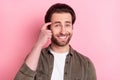 Photo of young cheerful man happy positive smile finger touch head think forget memory isolated over pink color Royalty Free Stock Photo