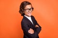 Photo of young cool smart attractive small boy hold hands crossed smile enjoy on orange color background