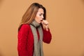 Photo of young coughing brunette woman in warm wear