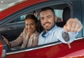 Photo of young couple sitting inside new car. Man showing keys to it. Concept for car rental Royalty Free Stock Photo