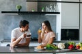 Young couple starting the day together with coffee in the kitchen