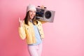 Photo of young crazy attractive woman girl female showing rock n roll sign hold boombox on shoulders isolated on pink Royalty Free Stock Photo