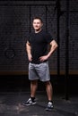 Photo of a young crossfit sportsman in sportwear while standing against brick wall. Royalty Free Stock Photo