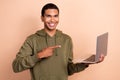 Photo of young it developer positive mood man wear khaki trendy sweatshirt hold laptop direct finger vacancy job