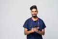 Photo of young doctor using his smartphone white background Royalty Free Stock Photo
