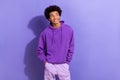 Photo of young dreaming man wearing sportswear hoodie hands pockets model minded look novelty isolated on purple color Royalty Free Stock Photo